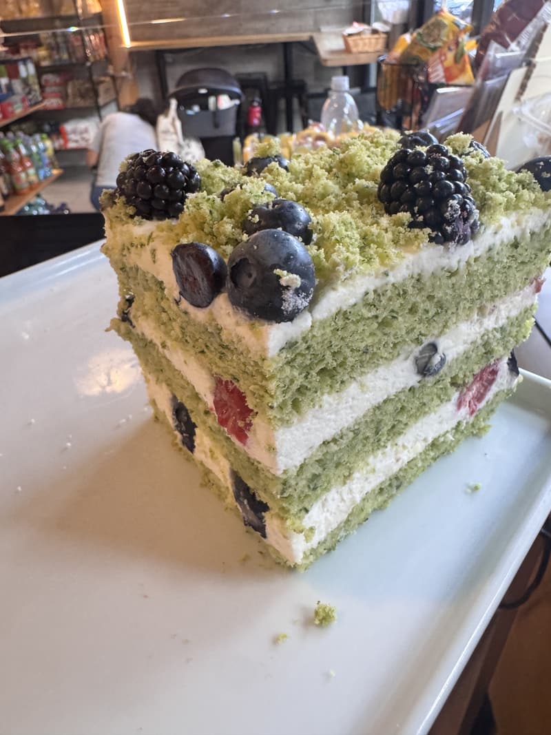 A layer cake topped with fresh berries